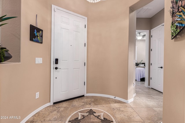 entrance foyer with ceiling fan