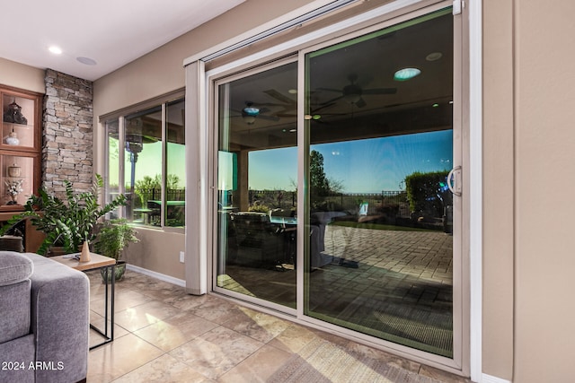 doorway to outside featuring ceiling fan