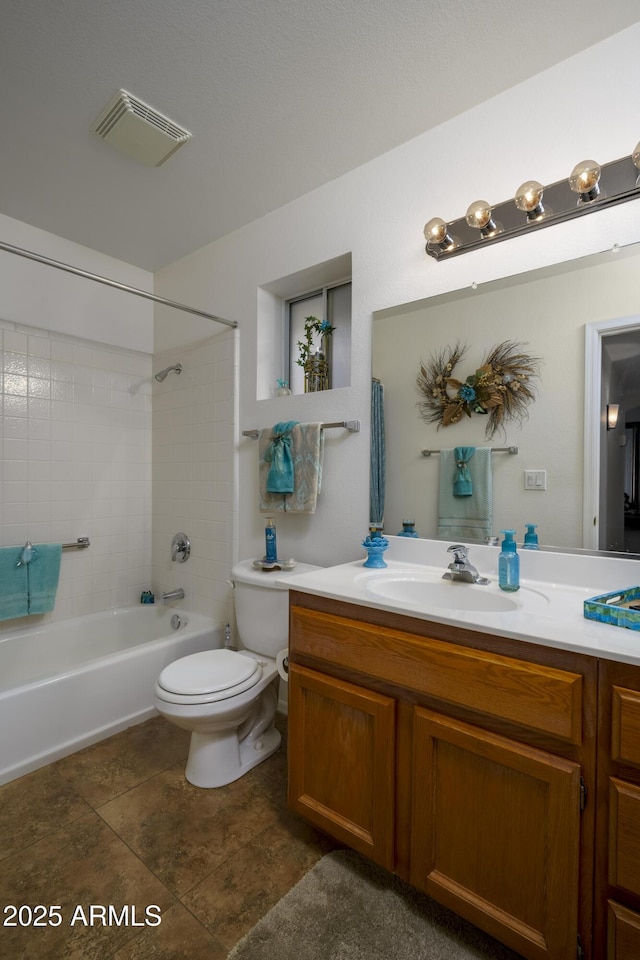 full bathroom featuring vanity, toilet, and tiled shower / bath