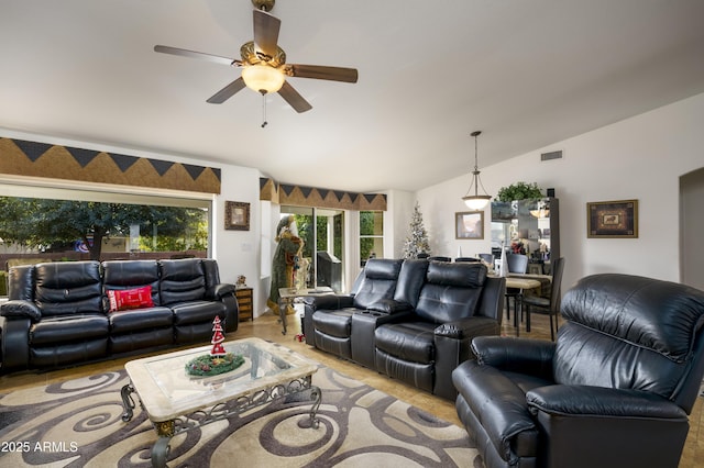 living room featuring ceiling fan, light wood-type flooring, and lofted ceiling