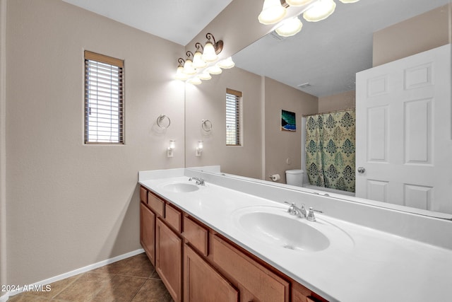 bathroom featuring walk in shower, tile patterned flooring, vanity, and toilet