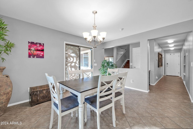 dining room featuring light tile patterned floors and a chandelier