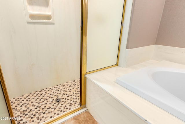 bathroom with tile patterned flooring and a shower