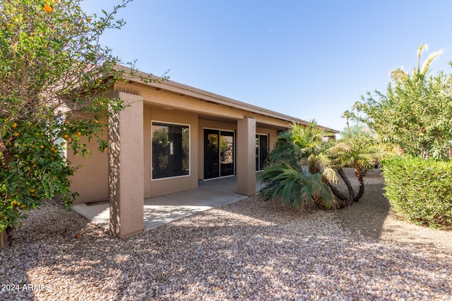 rear view of property featuring a patio area