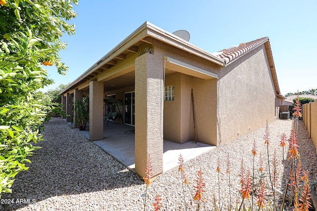 view of home's exterior with a patio and cooling unit