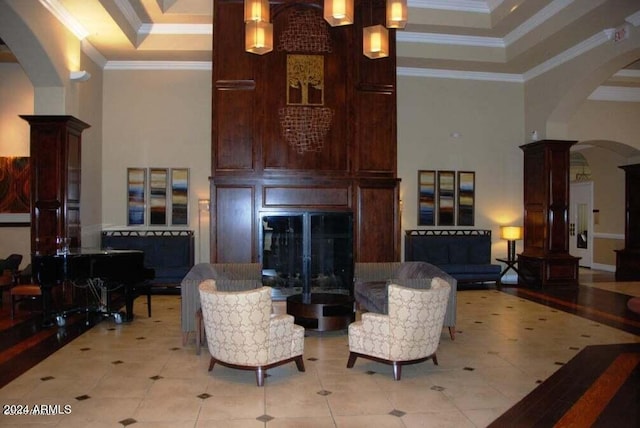 living room featuring a notable chandelier, crown molding, and a high ceiling