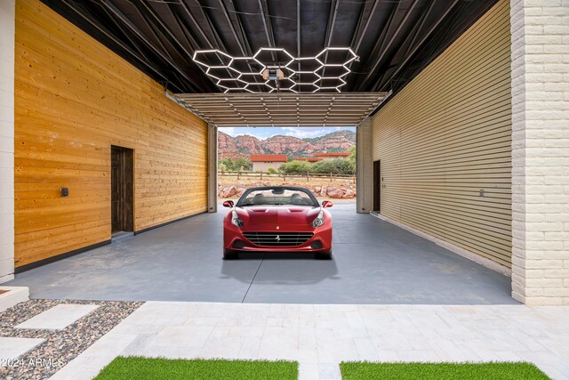 garage with a carport and fence