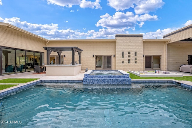 pool with outdoor dry bar, a patio area, an in ground hot tub, and a pergola