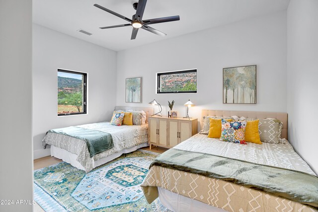 dining area featuring light wood finished floors, a ceiling fan, and baseboards