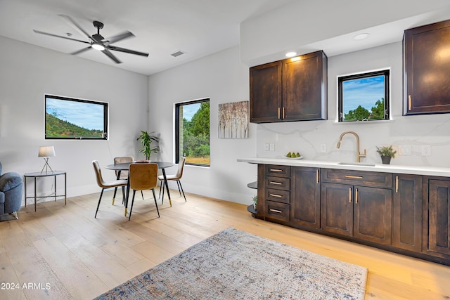 dining area with light wood-type flooring, baseboards, and ceiling fan