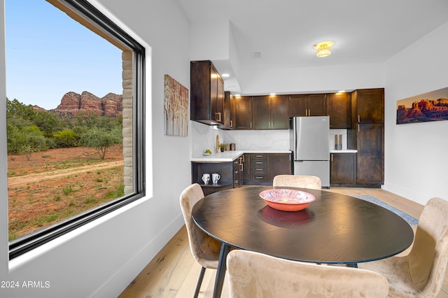 dining room with light wood-type flooring and baseboards