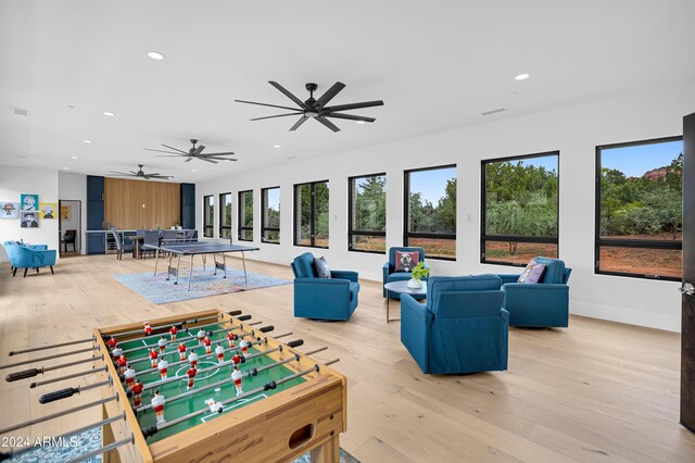 recreation room with recessed lighting, baseboards, and wood-type flooring