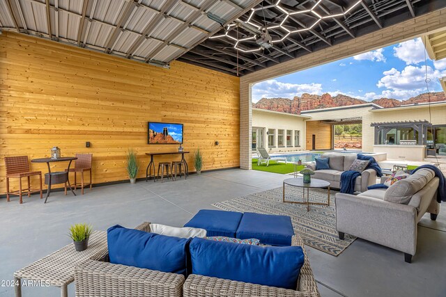 view of patio / terrace featuring an outdoor living space, a swimming pool, and a pergola