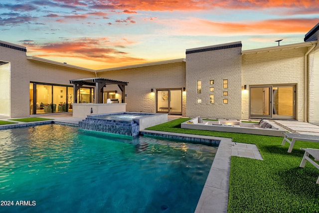 pool with a patio, an in ground hot tub, and a pergola