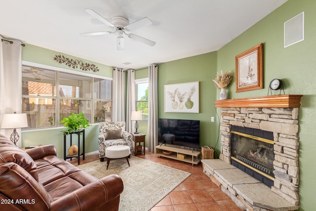 living room with ceiling fan, light tile patterned flooring, and a fireplace