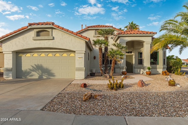 mediterranean / spanish house featuring a garage