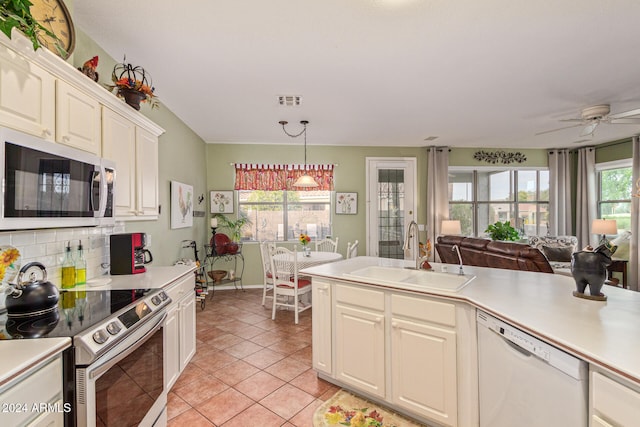 kitchen featuring stainless steel appliances, sink, tasteful backsplash, light tile patterned floors, and ceiling fan