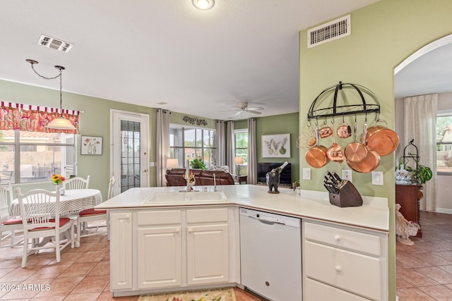 kitchen featuring white dishwasher, sink, light tile patterned flooring, ceiling fan, and white cabinetry