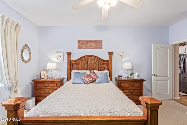 carpeted bedroom featuring ceiling fan and stainless steel refrigerator