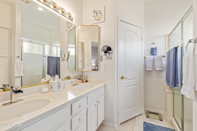 bathroom featuring walk in shower, vanity, and tile patterned floors