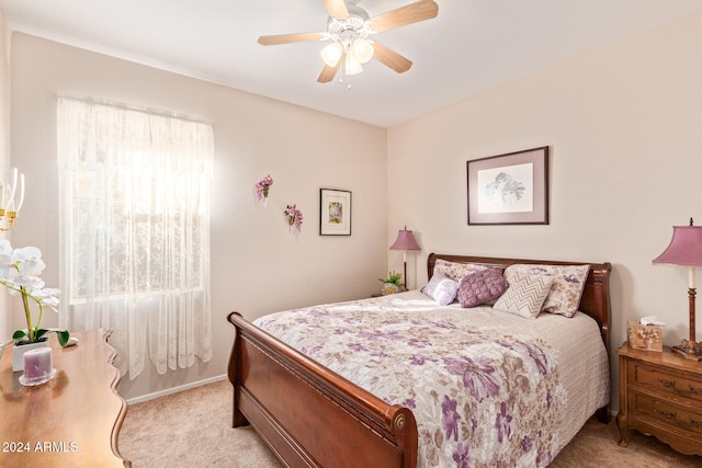 bedroom with ceiling fan and light carpet