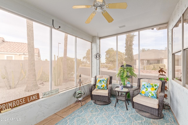 sunroom / solarium featuring a wealth of natural light and ceiling fan