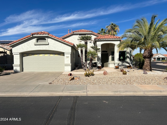 mediterranean / spanish house featuring a garage