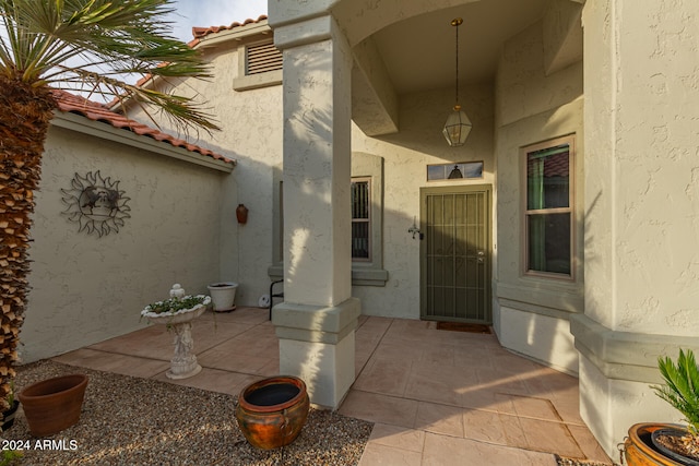 view of exterior entry featuring a patio