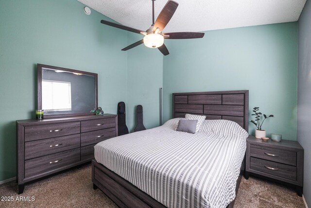 carpeted bedroom with ceiling fan and a textured ceiling