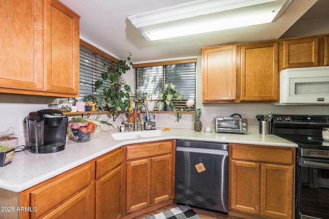 kitchen featuring light countertops, white microwave, a sink, range with electric cooktop, and dishwasher