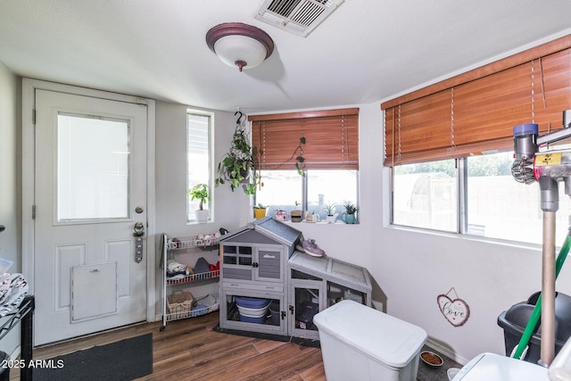 interior space featuring dark wood finished floors and visible vents