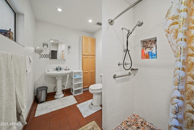 bathroom with tile patterned floors, curtained shower, and toilet