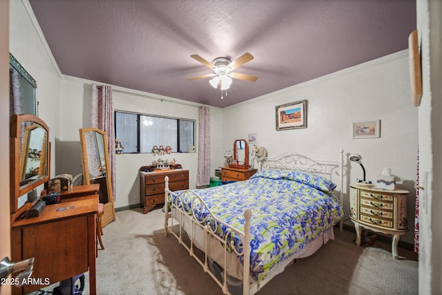 carpeted bedroom featuring ceiling fan, ornamental molding, and a textured ceiling