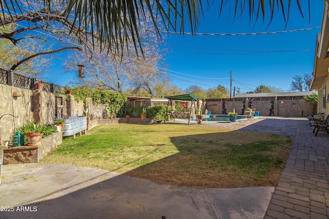 view of yard featuring a fenced in pool and a patio