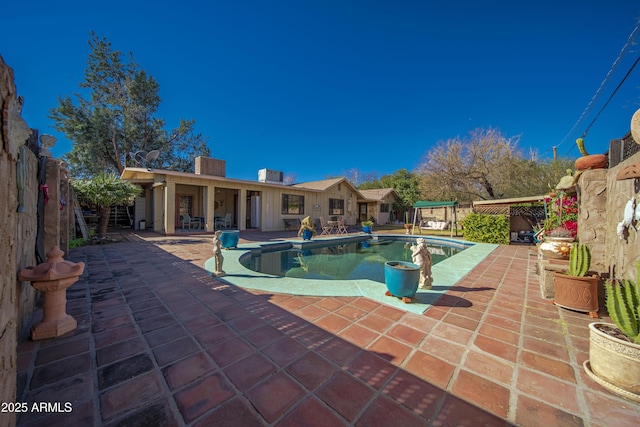 view of swimming pool with a patio area