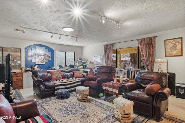 living room with track lighting and a textured ceiling