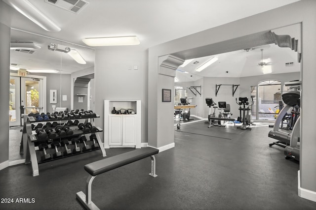 gym with ceiling fan and lofted ceiling