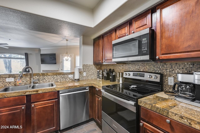 kitchen featuring tasteful backsplash, a healthy amount of sunlight, sink, and stainless steel appliances