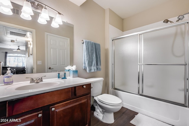 full bathroom with vanity, ceiling fan, enclosed tub / shower combo, hardwood / wood-style floors, and toilet