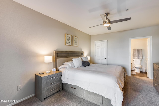 bedroom featuring ensuite bath, dark carpet, and ceiling fan