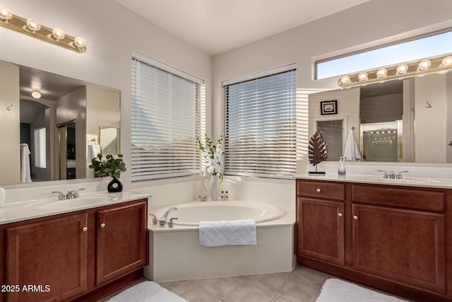 bathroom featuring tile patterned floors, shower with separate bathtub, and vanity