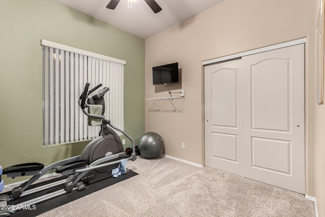 workout area featuring ceiling fan and light carpet