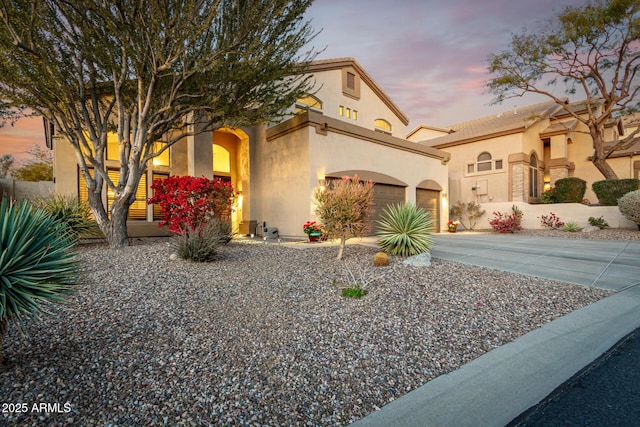 mediterranean / spanish-style home with a garage