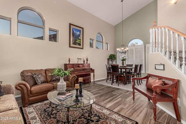 living room featuring a chandelier and high vaulted ceiling