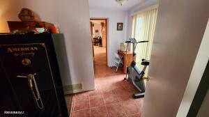 hall with light tile patterned floors