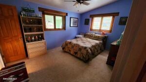 bedroom featuring ceiling fan and lofted ceiling