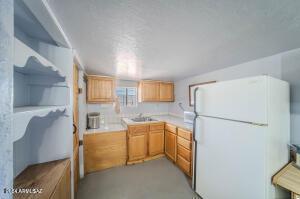 kitchen featuring white fridge and sink