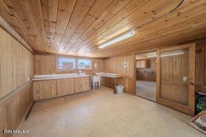 basement with wooden ceiling and wood walls