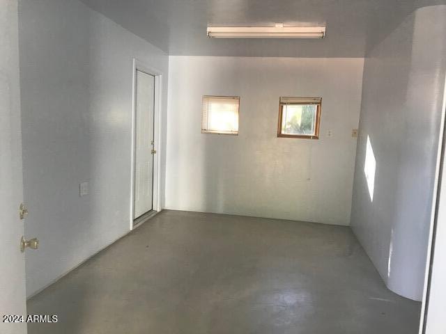 spare room with concrete flooring