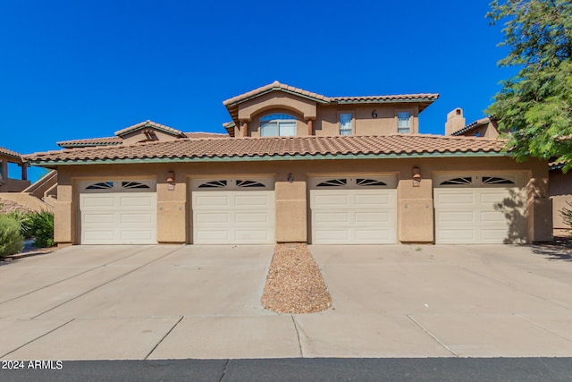 mediterranean / spanish-style house with a garage